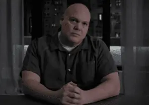 Wilson Fisk sits facing the camera with a calculating expression.