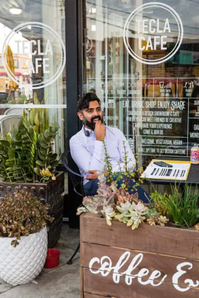 Sameer Gardezi in front of Tecla Cafe