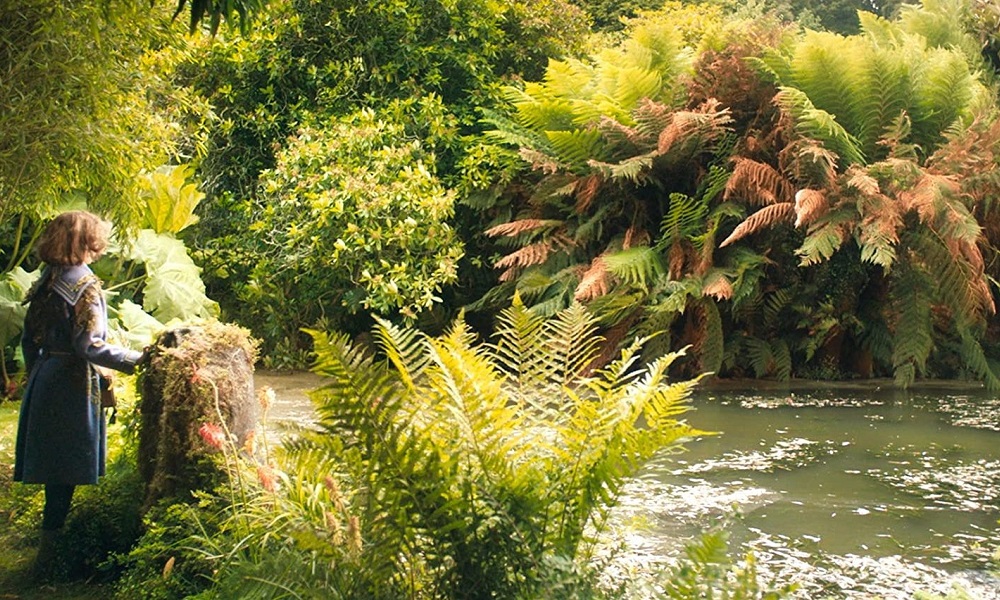 The Secret Garden On Healthy Environments and Imperialism - FM+ 3 young girl staring into the distance in a lush green secret garden