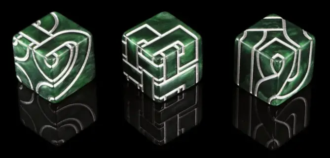 three green dice with silver celtic designs