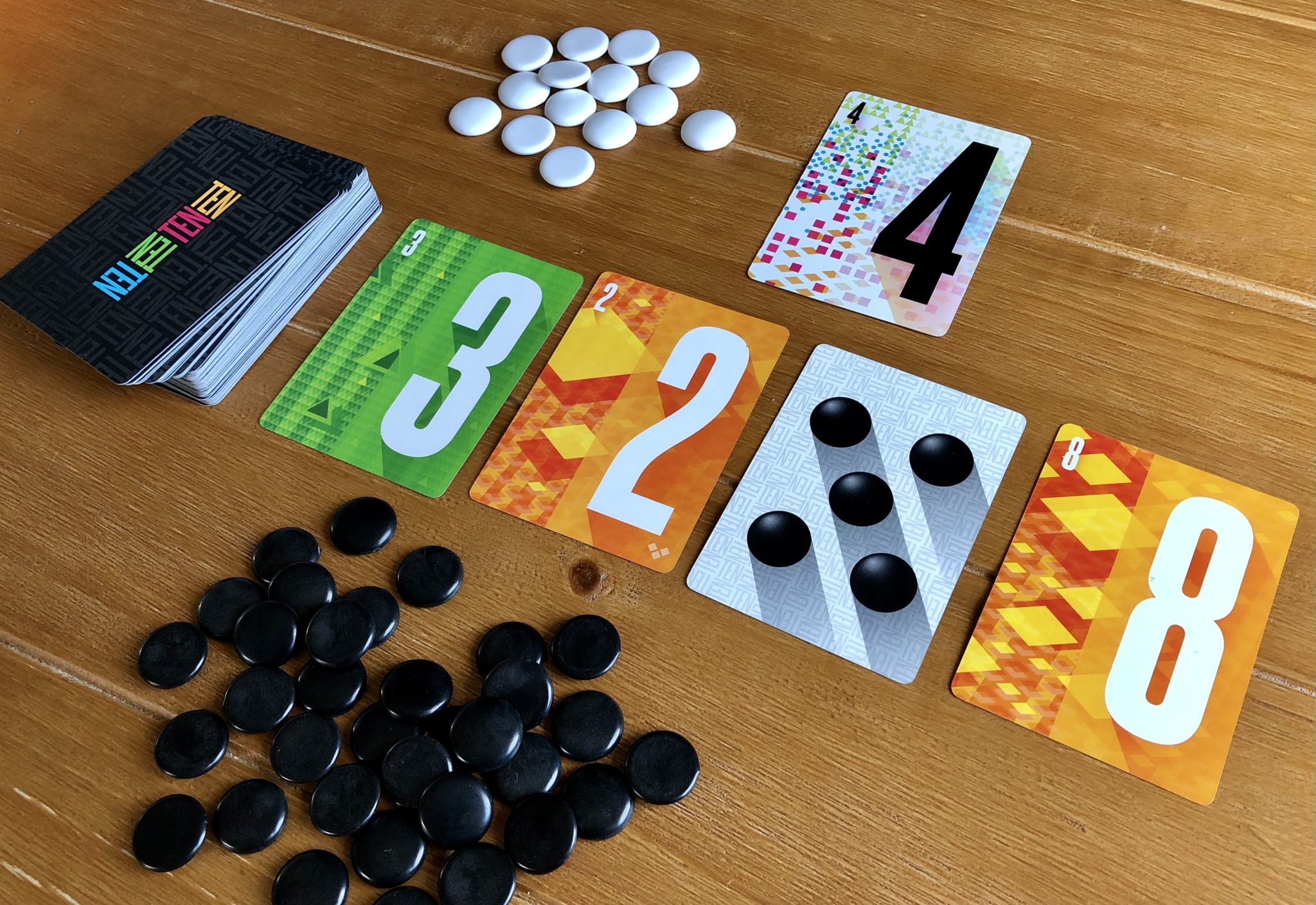 Does Ten Deserve a 10/10? 4 TEN card game on the table
