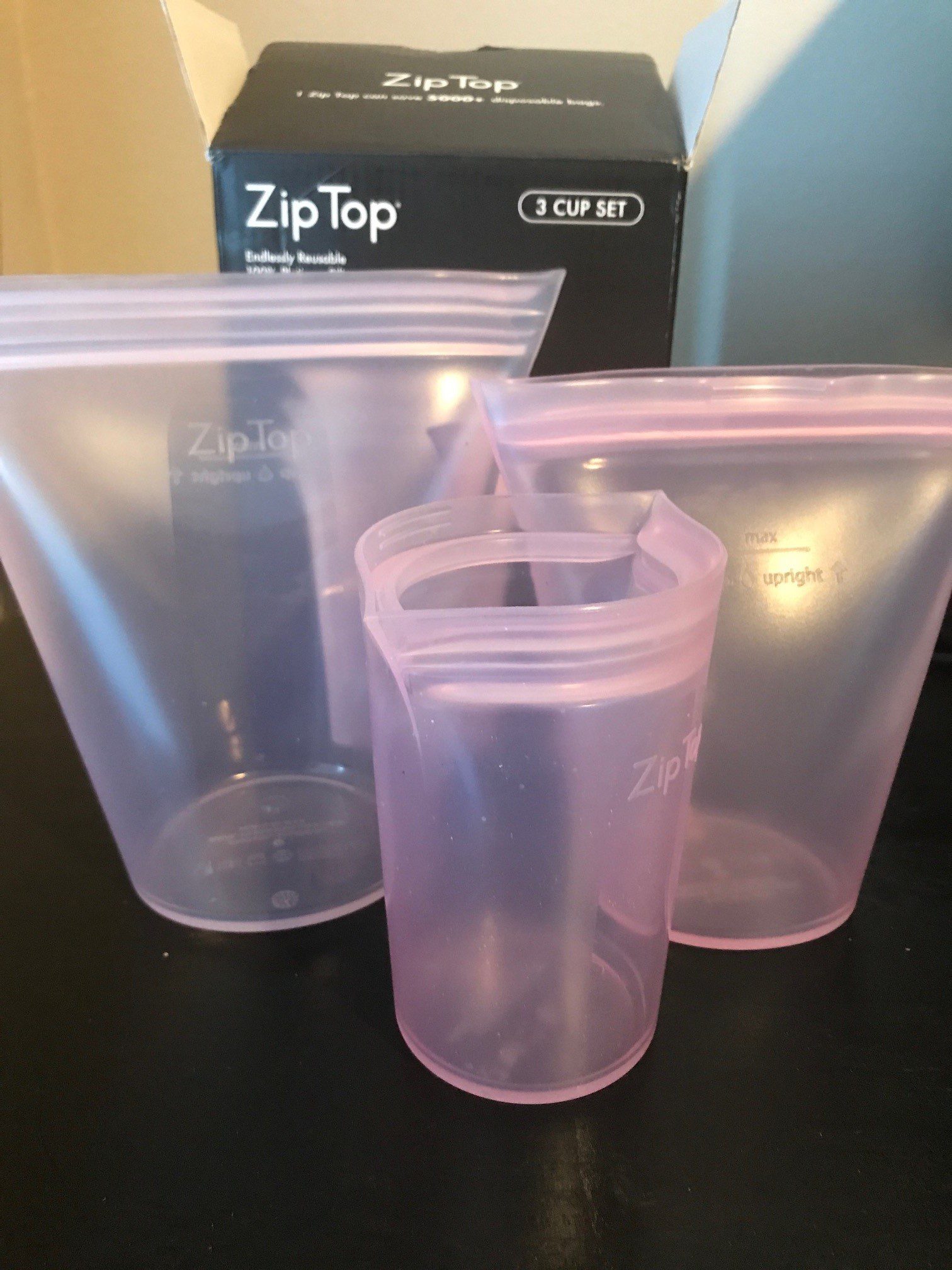 three pink silicone zippered containers