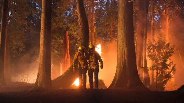 broadcast series Fire Country, two characters in a forest with a fire behind them