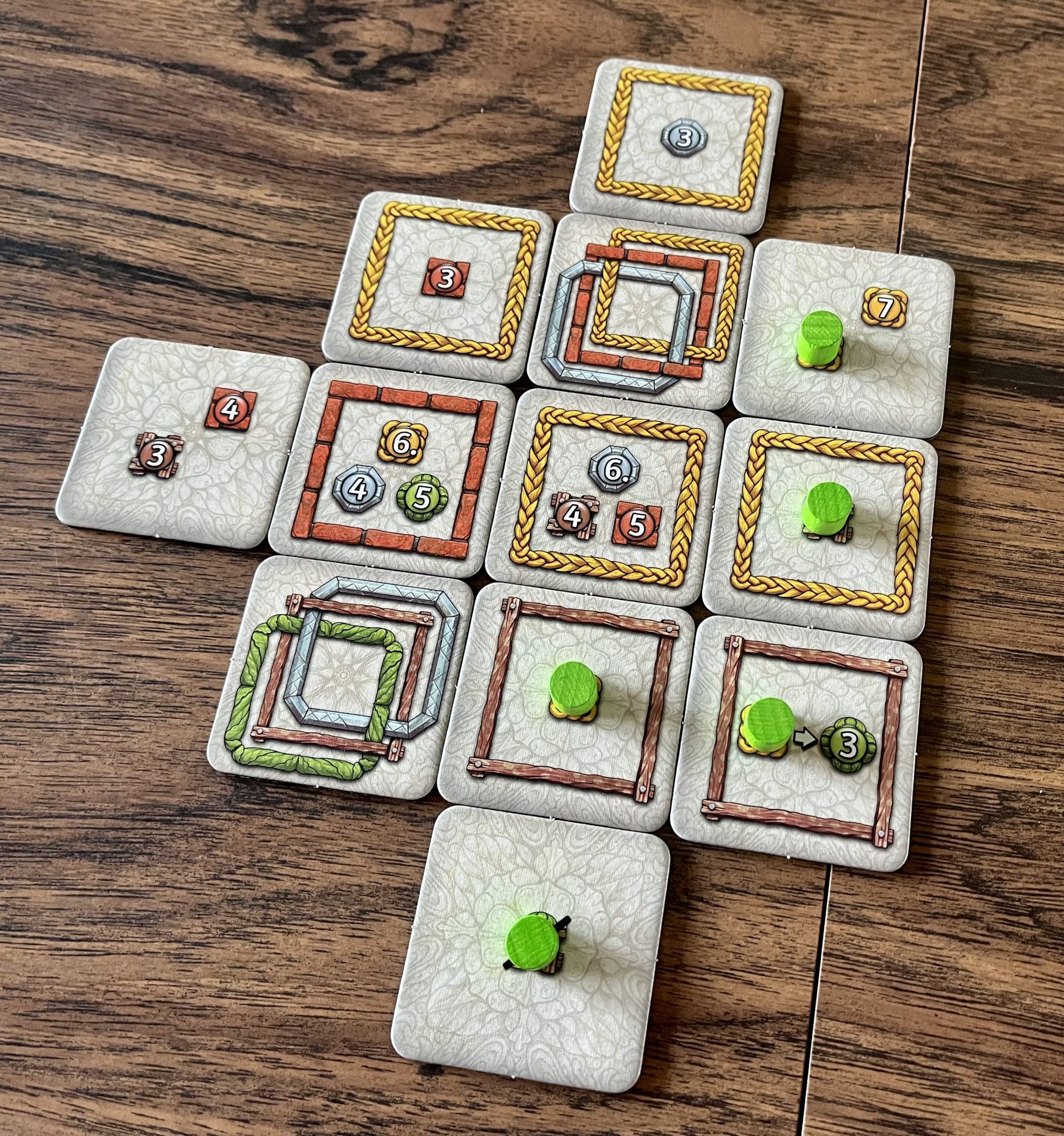 Uwe Rosenberg's Latest 'Framework' Makes Strategy The Star 8 Framework tiles on the table