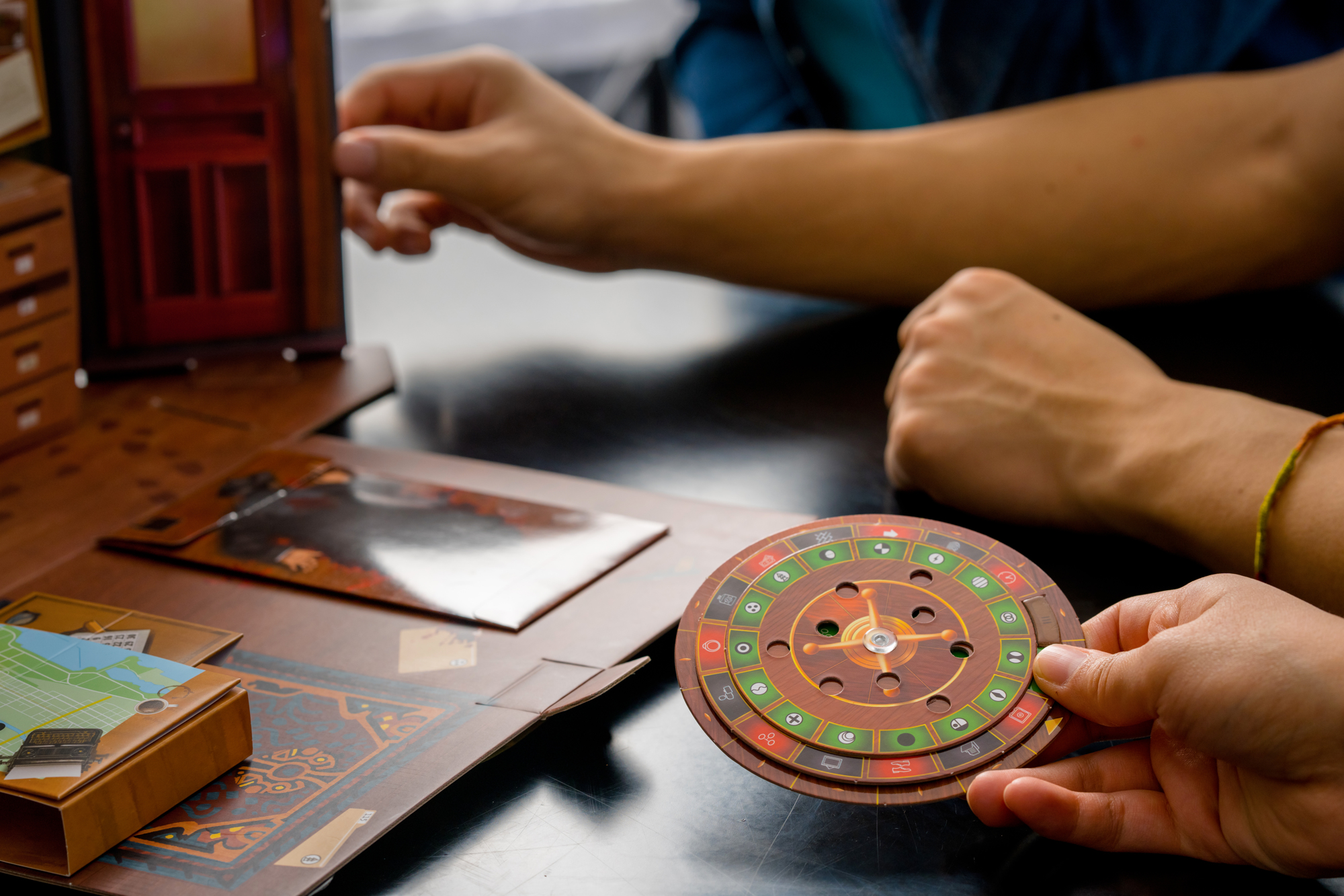 hands holding a solution wheel while another pair of hands hold the game