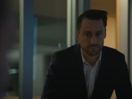 Roman in a meeting from Succession