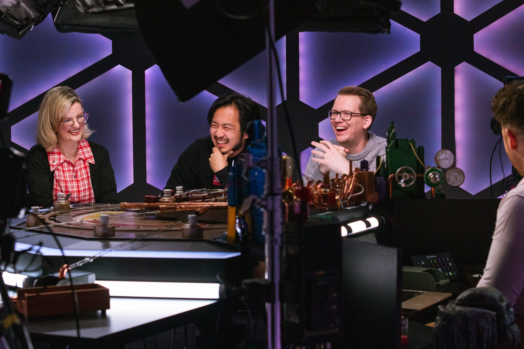 The cast of mentopolis at the table. From left to right: Siobhan Thompson, Freddie Wong, and Hank Green