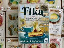 Fika on the table with cards