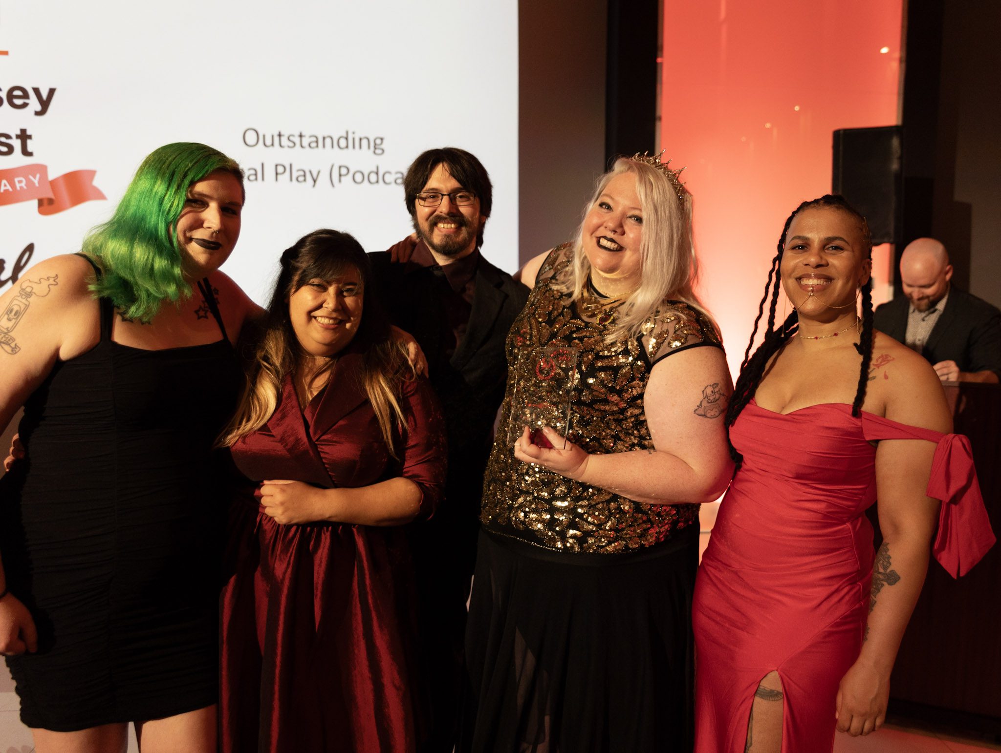 The cast of The All Night Society winning their award for Outstanding Actual Play Podcast