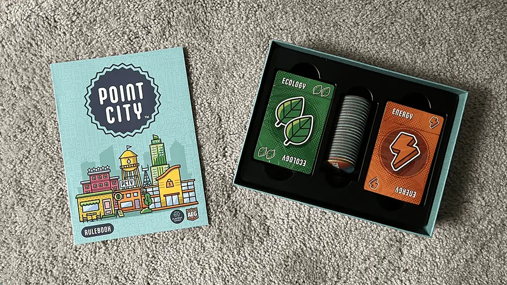 Contents of the Point City Box, including a rulebook, cards, and tokens.