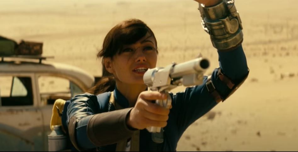 Lucy aims a gun at a subject of conversation from Fallout