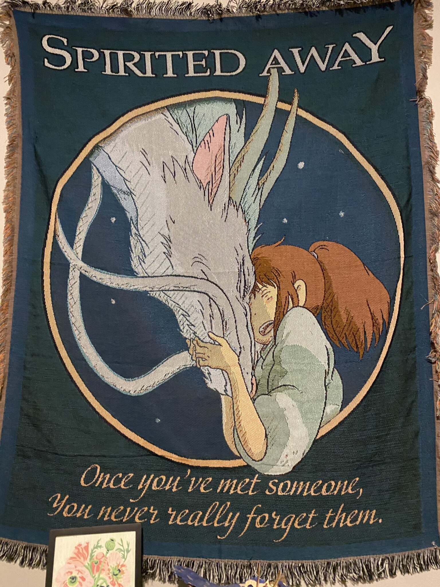 Chihiro hugging Haku in spirited away above the words "Once you've met someone, you never really forget them."