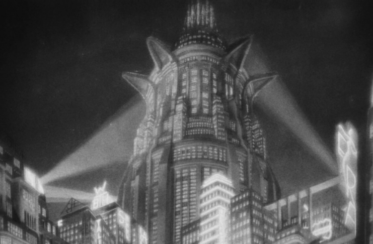 Metropolis rises into the sky lit by searchlights