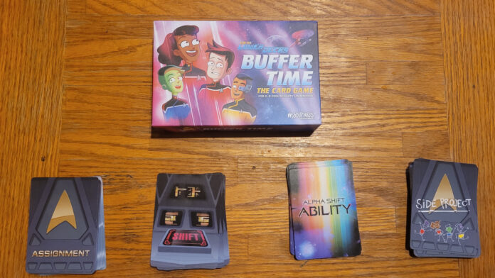 photo of the box for 'Star Trek: Lower Decks: Buffer Time" along with four stacks of cards (Assignment, Shift, Alpha Shift Ability, Side Project"