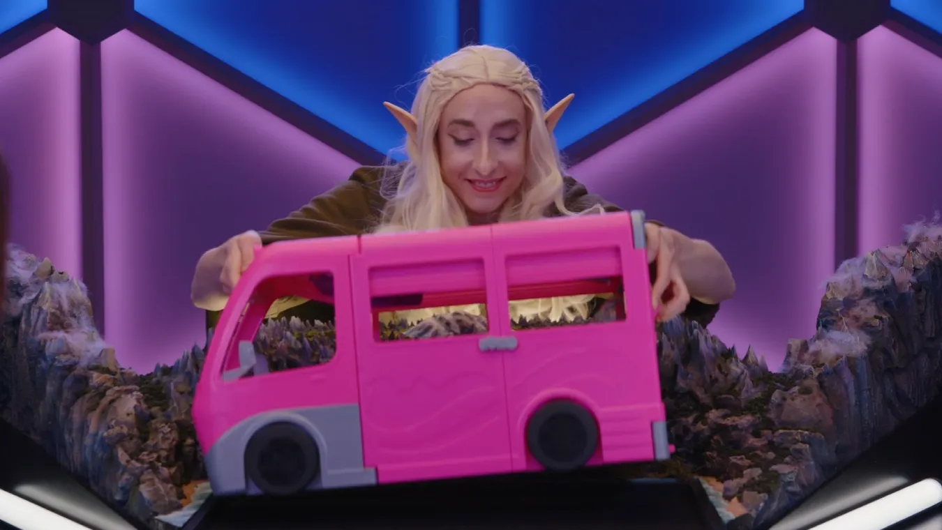 Dimension 20: Blithe, Baffled, And Bewildered By Brennan And A Bus 2 Katie placing the hot pink toy bus on the table.