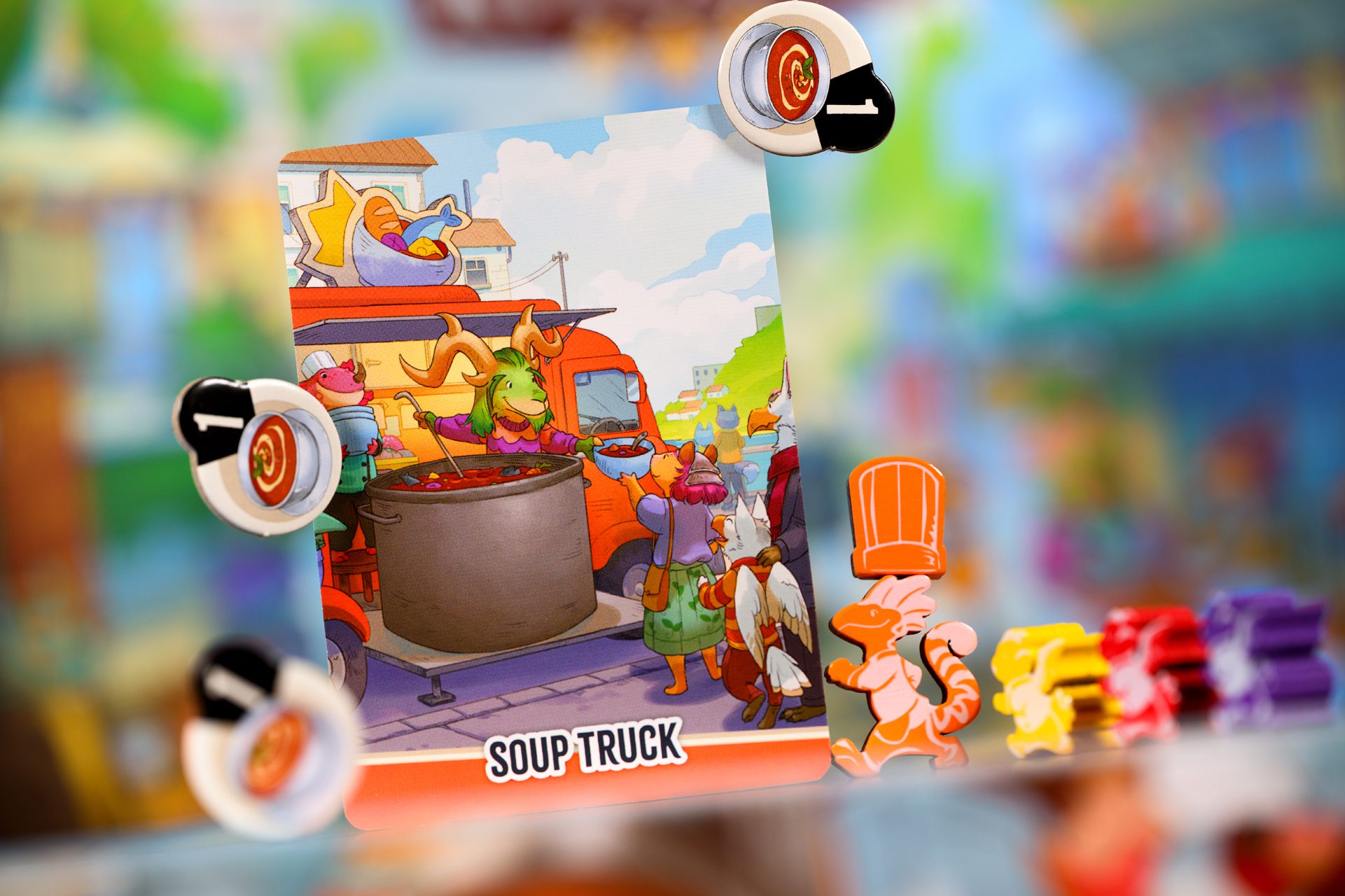 Soup truck card, soup tokens, an orange zous-chef, and different colored meeples.