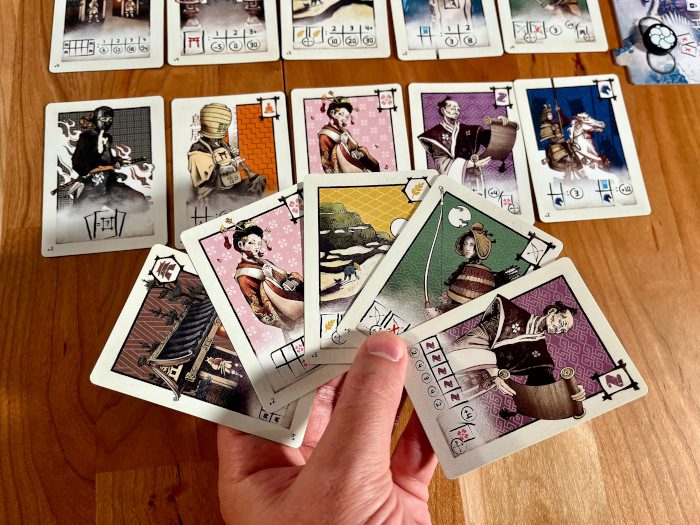 Naishi- end game look with line and hand of cards